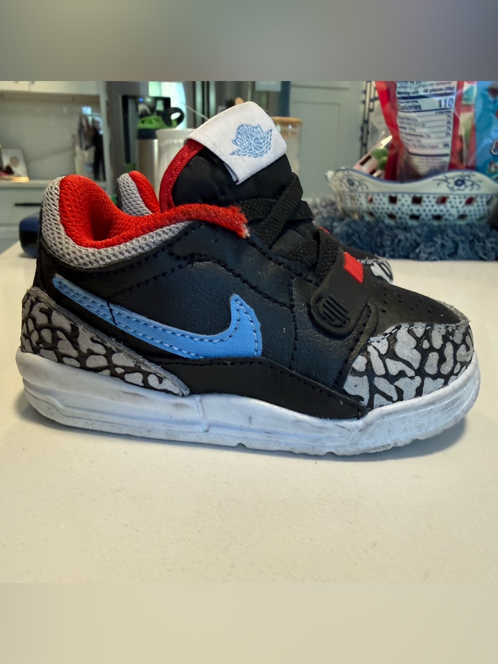 Jordan Kids Black Sneakers with Blue Swoosh and Red Lining